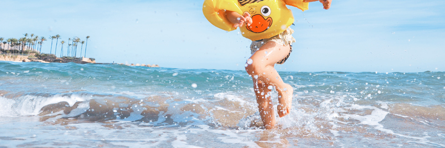 Child playing in the beach. Sometimes swimming causes brain injury if rules are not followed.
