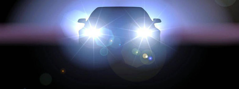 Car with lights on in the dark. Inside dashboard if car showing GPS on mobile phone. What to do after a car accident injury. Car accident injury lawyer in Whitby. Accident lawyer in Oshawa. Personal injury lawyer in Whitby, Vaughan, and Oshawa, ON.