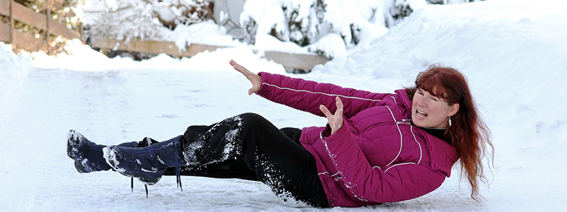 Woman slipping and falling in winter conditions