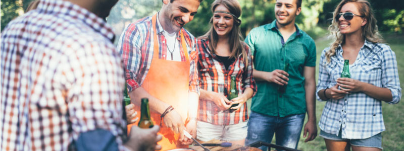 A group of friends around the grill. Barbecue Safety