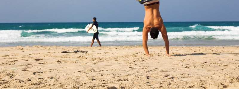 A man and a surfer on the beach enjoying the sun. Sun safety