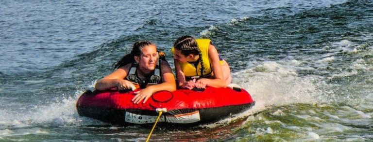 two girls in a tube in the water in summertime. Peak time for brain injuries. Conte Jaswal Personal Injury Lawyers in Oshawa, Whitby, and Vaughan.